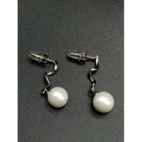 907 - Pair of pearl drop earrings set in silver, presentation box.