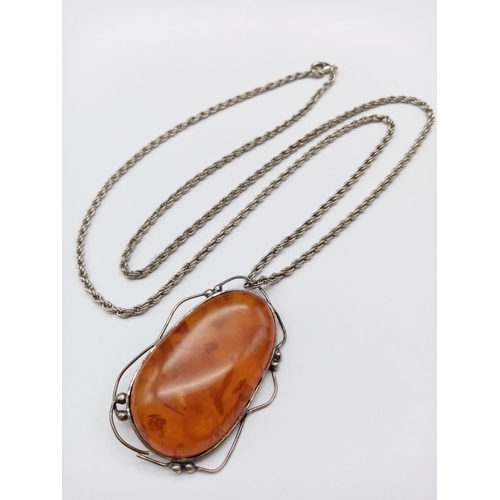 985 - Large Amber Stone Pendant on White Metal Chain.
76cm