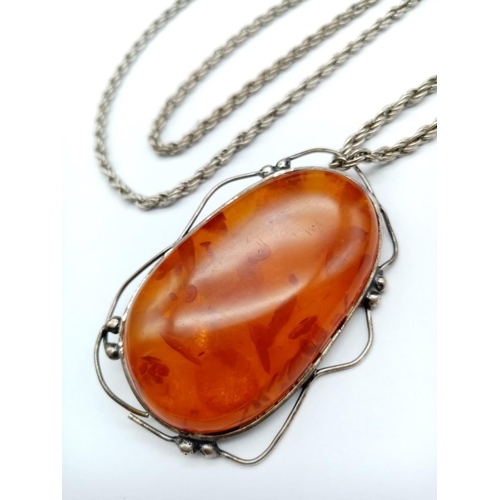 985 - Large Amber Stone Pendant on White Metal Chain.
76cm