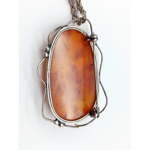 985 - Large Amber Stone Pendant on White Metal Chain.
76cm