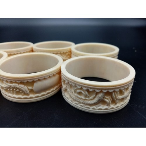 542 - Six Antique Ivory Hand-Carved with Chinese Decoration Napkin Rings. 5cm diameter.