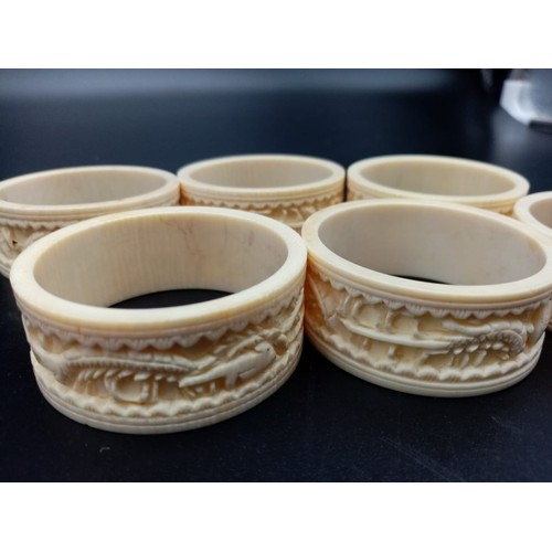 542 - Six Antique Ivory Hand-Carved with Chinese Decoration Napkin Rings. 5cm diameter.