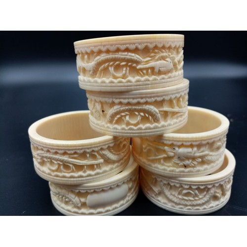 542 - Six Antique Ivory Hand-Carved with Chinese Decoration Napkin Rings. 5cm diameter.