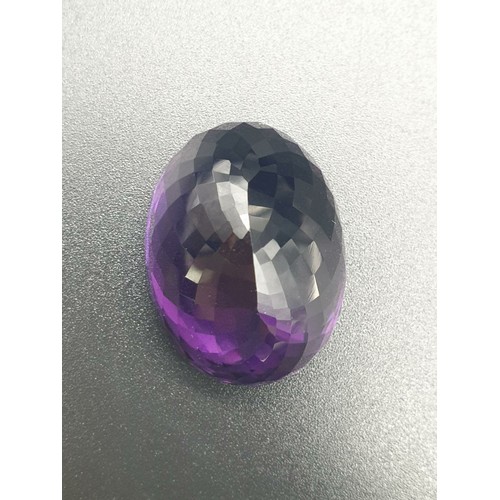 133 - A Natural Purple Amethyst in Oval Faceted. Total 69.69ct
28.80 x 22.00 x 16.75mm. Come with AIG Cert... 