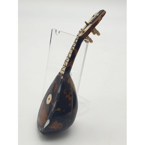 746 - Victorian tortoise shell decorated on wood ornament in the form of musical instrument