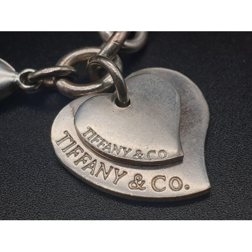 328 - Silver Bracelet with Two Tiffany Heart Charms. 18cm.
31g total weight.