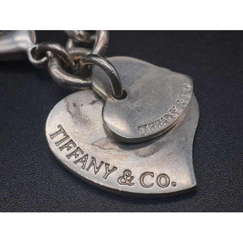 328 - Silver Bracelet with Two Tiffany Heart Charms. 18cm.
31g total weight.