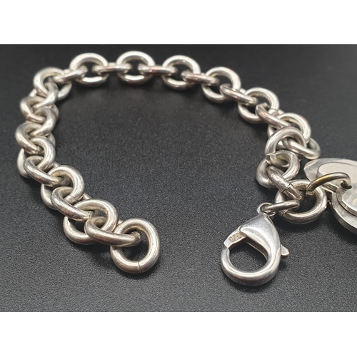 328 - Silver Bracelet with Two Tiffany Heart Charms. 18cm.
31g total weight.
