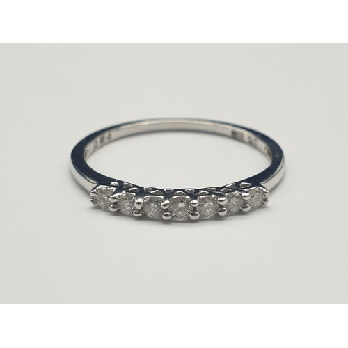 355 - 9K White Gold Diamond Set Seven-Stone Ring. 
0.2 Carat. 1.3g. Size O