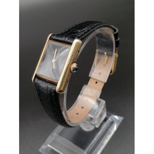 15 - Must de Cartier ladies wristwatch with black square face, gold plate and leather strap, 26mm x 20mm
