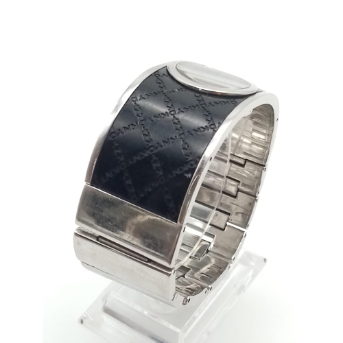 317 - DKNY Ladies Dress Watch. Black Monogramed Leather on Stainless Steel Strap. Black Dial. As found.