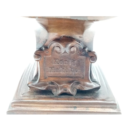 45 - Antique German Bronzed Spelter Cigar Lighter Bust of Konig Makoke. Raised on a square plinth, with g... 