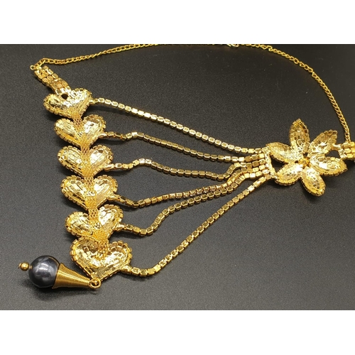 140 - A highly glamorous asymmetric necklace and matching earrings in a presentation box. With glittering ... 