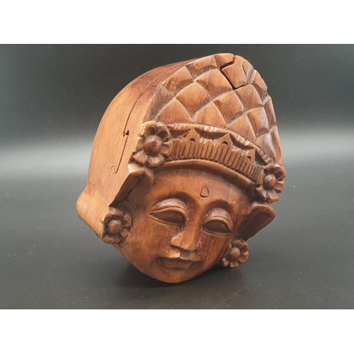 154 - A puzzle, hand carved, wooden, trinket box in the shape of a Deity seen at Angkor
Wat, Cambodia. Whe... 