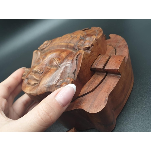 154 - A puzzle, hand carved, wooden, trinket box in the shape of a Deity seen at Angkor
Wat, Cambodia. Whe... 