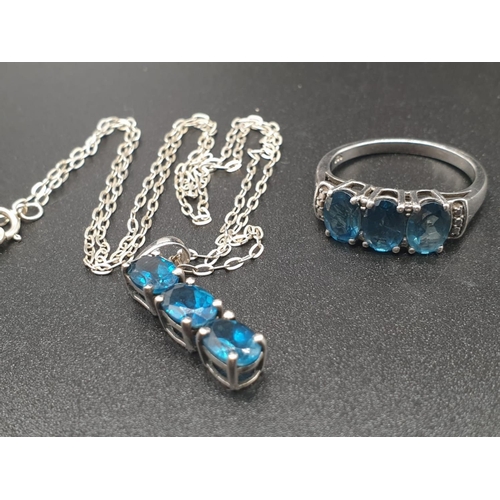 182 - A sterling silver (hallmarked) set of a pendant and matching ring with three faceted, oval, blue sap... 