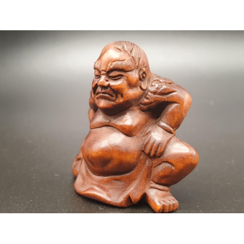 196 - An intricately carved boxwood netsuke of a Sumo wrestler on a ceremonial pose. Signed at the bottom ... 