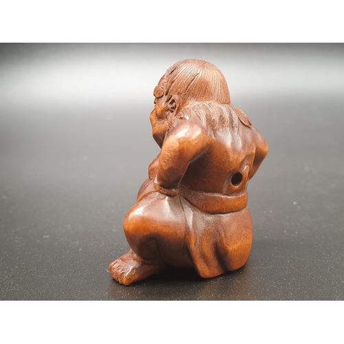 196 - An intricately carved boxwood netsuke of a Sumo wrestler on a ceremonial pose. Signed at the bottom ... 