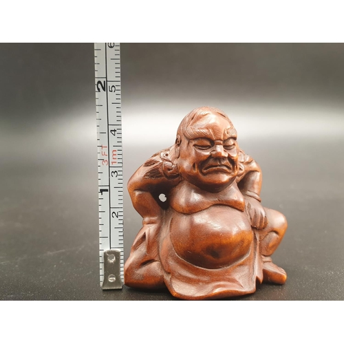 196 - An intricately carved boxwood netsuke of a Sumo wrestler on a ceremonial pose. Signed at the bottom ... 