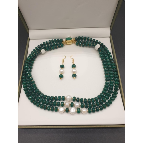 50 - A beautiful and substantial three row necklace of faceted emeralds with accents of large natural pea... 