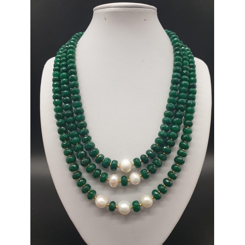 50 - A beautiful and substantial three row necklace of faceted emeralds with accents of large natural pea... 