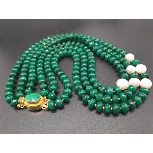 50 - A beautiful and substantial three row necklace of faceted emeralds with accents of large natural pea... 