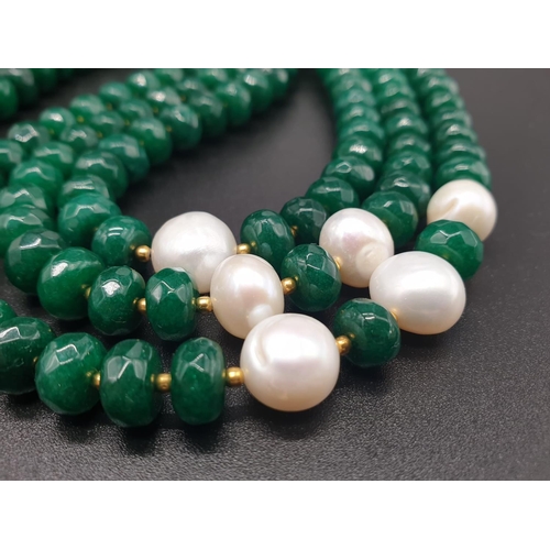 50 - A beautiful and substantial three row necklace of faceted emeralds with accents of large natural pea... 