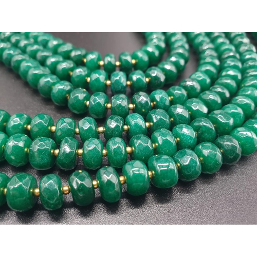 50 - A beautiful and substantial three row necklace of faceted emeralds with accents of large natural pea... 