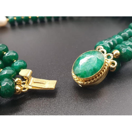 50 - A beautiful and substantial three row necklace of faceted emeralds with accents of large natural pea... 