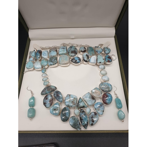 64 - A very attractive and unique looking LARIMAR necklace, bracelet and earrings set in a presentation b... 