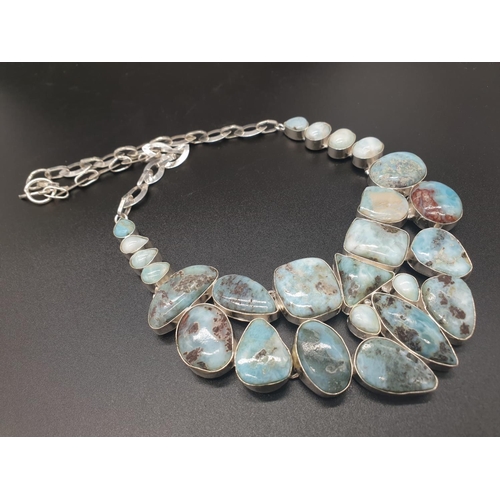 64 - A very attractive and unique looking LARIMAR necklace, bracelet and earrings set in a presentation b... 