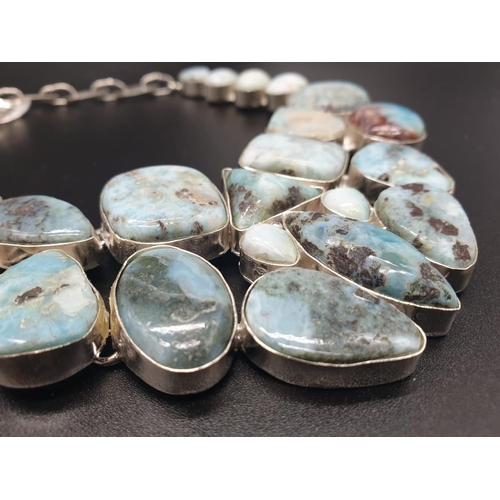 64 - A very attractive and unique looking LARIMAR necklace, bracelet and earrings set in a presentation b... 