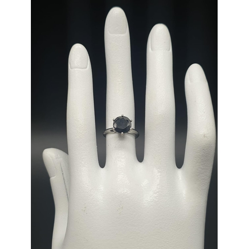 187 - 14ct white gold single solitaire with a fancy black round brilliant cut 1.25ct diamond, ring size J.... 