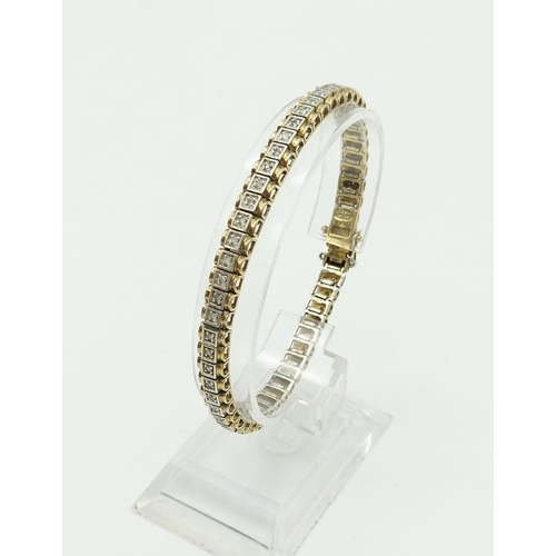 235 - A Silver Gilt and Diamond Tennis Bracelet. 20cm.
17.3g total.