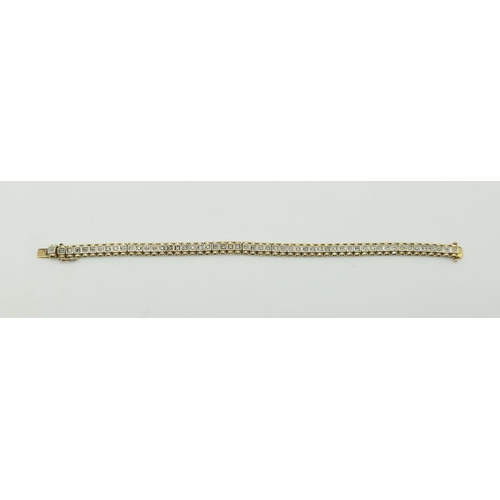 235 - A Silver Gilt and Diamond Tennis Bracelet. 20cm.
17.3g total.