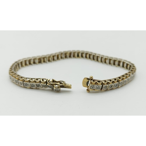 235 - A Silver Gilt and Diamond Tennis Bracelet. 20cm.
17.3g total.