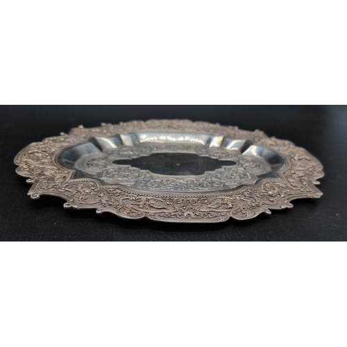 309 - An Antique Burmese Silver Dish. Beautiful embossed animal decoration. 23 x 17.5 cm. 182g