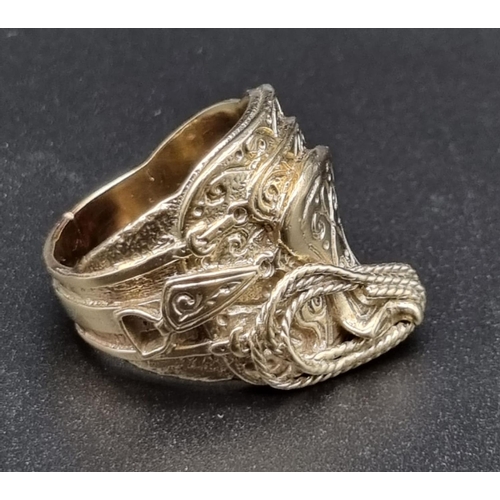 138 - 9ct yellow gold ring in a western cowboy saddle design, ring size X/Y. Total weight 25.6 grams