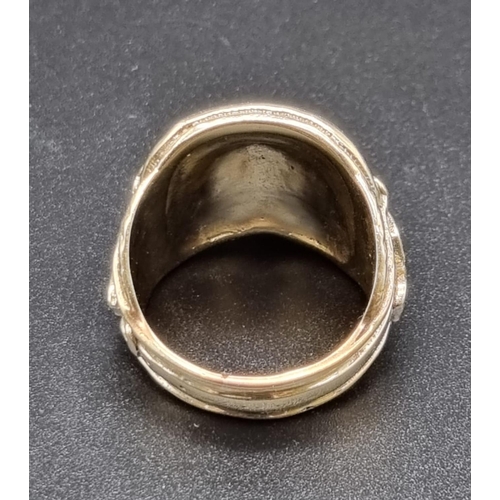 138 - 9ct yellow gold ring in a western cowboy saddle design, ring size X/Y. Total weight 25.6 grams