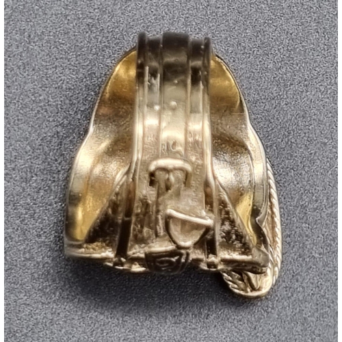 138 - 9ct yellow gold ring in a western cowboy saddle design, ring size X/Y. Total weight 25.6 grams