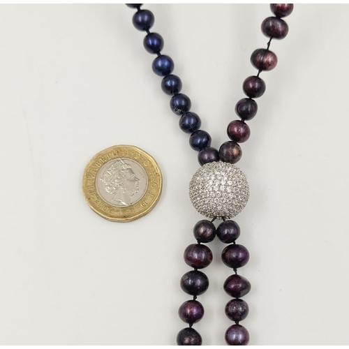 144 - A Two-Strand Cultured Purple Pearl Necklace. 120cm