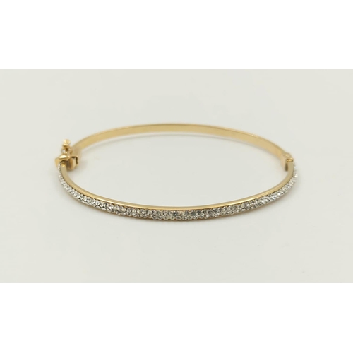 242 - A 9K Yellow Gold Half Eternity Diamond Bangle.
6cm diameter. 3.7g