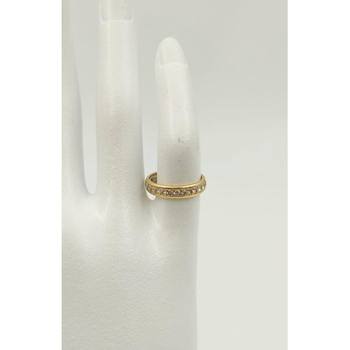 148 - An 18K Yellow Gold Diamond Eternity Ring. Size F.
2.8g