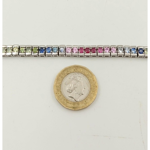 262 - An Absolutely Gorgeous Silver Multi-Coloured Sapphire Bracelet. Over 50 Sapphires! 18cm length.