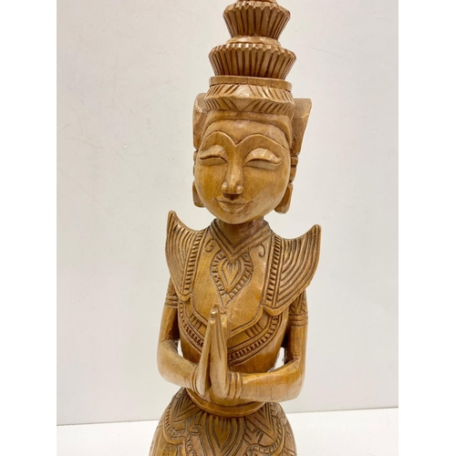 340 - Tall wood carving art of Thai Buddha figure, kneeling in prayer. 57cm in height.