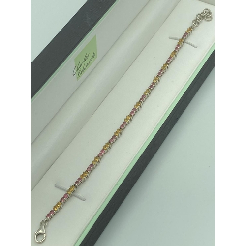 118 - SILVER and TOURMALINE TENNIS BRACELET having natural pink and yellow gemstones set in articulated si... 