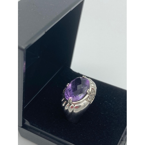 210 - SILVER and AMETHYST RING having large oval faceted Amethyst  set to top. Size N 1/2.