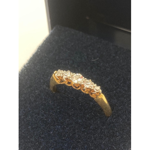 217 - 18 carat GOLD RING having five graduated DIAMONDS set to top. Quality dainty ring.