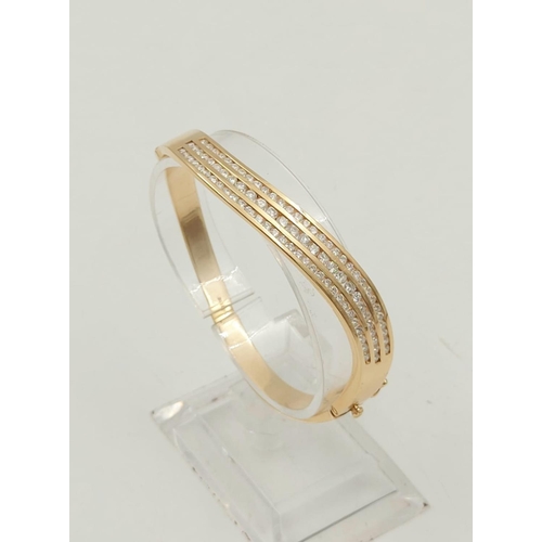 282 - A Stunning 14K Yellow Gold Diamond Twist Bracelet.
Over 100 bright-white dancing diamonds. 25.52g