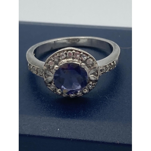 371 - SILVER ring having blue solitaire mounted to  top with clear stone collar and shoulders.
Size O.